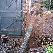 Compost heap, in a home-made, rather wobbly, structure.