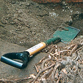 Spade, resting on a partly-dug hole